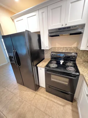 a stove top oven sitting inside of a kitchen