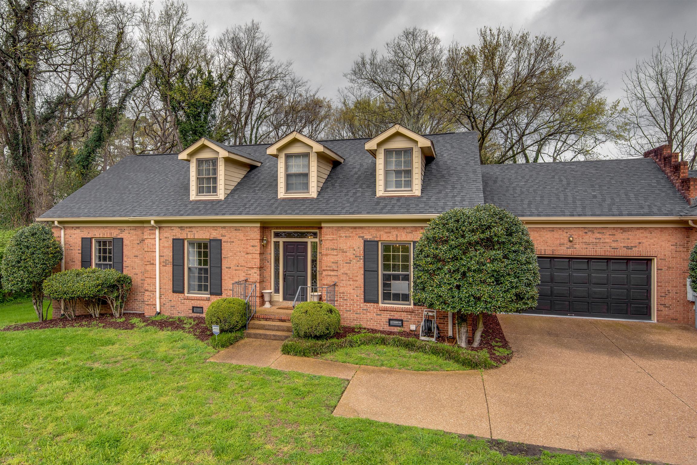 3600 Hobbs Road Nashville, TN 37215 - Photo 1 of 29 a front view of a house with a yard and garage