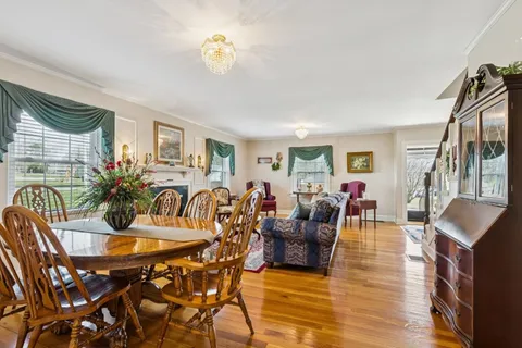a living room with furniture dining table and a window