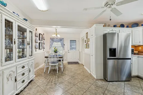 a view of a kitchen with furniture fridge and wooden floor