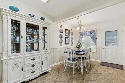 a view of a dining room with furniture and chandelier