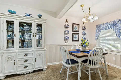 a view of a dining room with furniture and chandelier