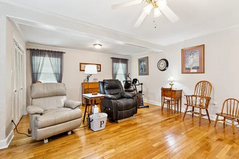 a living room with furniture and wooden floor