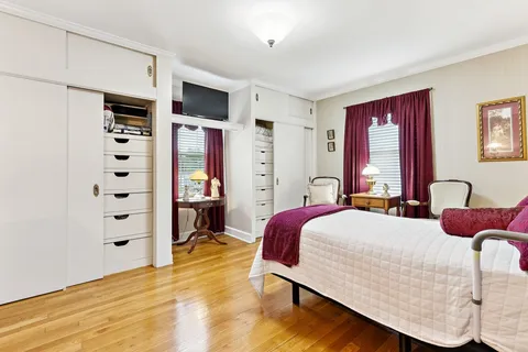a bedroom with a bed cabinets and window
