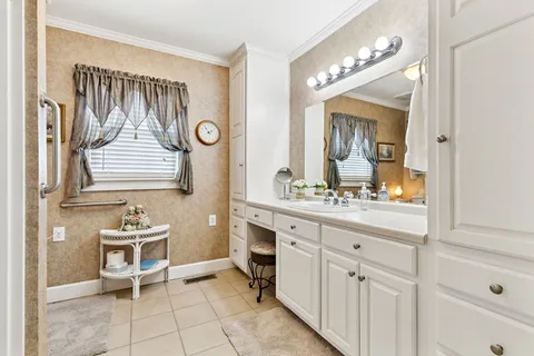 a bathroom with a sink a light fixture and a mirror