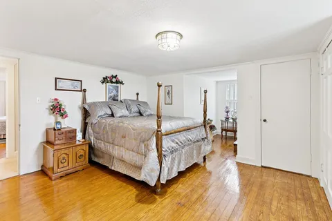 a bedroom with a bed and a view of kitchen