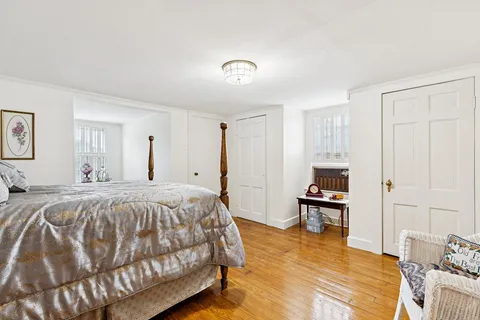 a spacious bedroom with a bed and a table in it