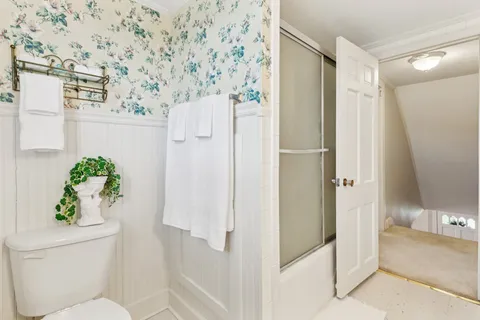 a bathroom with a shower and a toilet