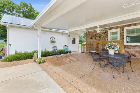 a patio with table and chairs