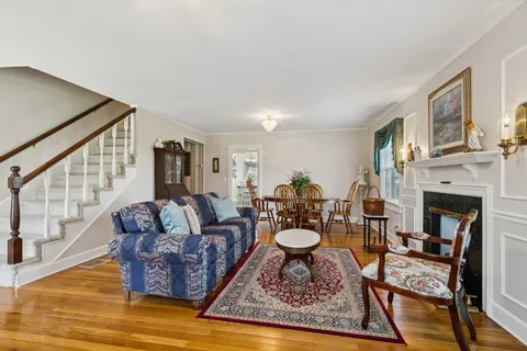 a living room with furniture a fireplace and a table