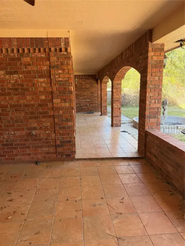 a view of entrance gate with wooden floor