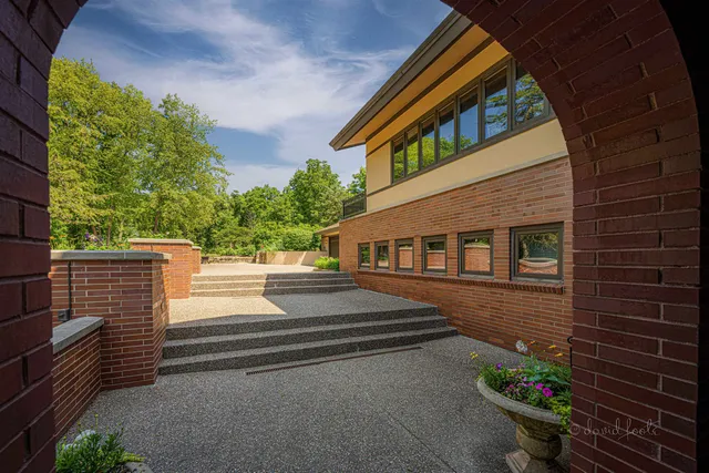 a living room with furniture and a book shelf