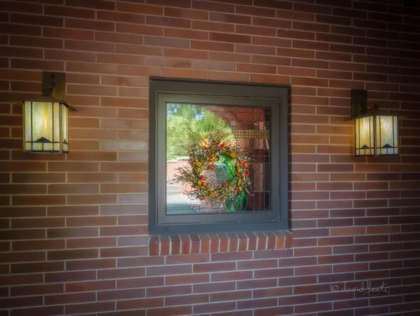 a living room with furniture a rug and a floor to ceiling window