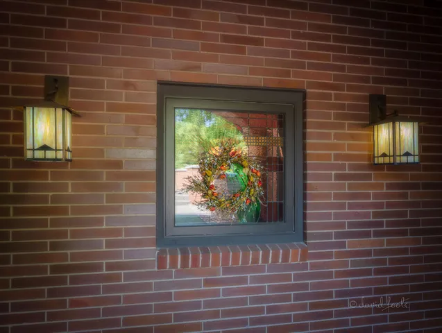 a living room with furniture a rug and a floor to ceiling window