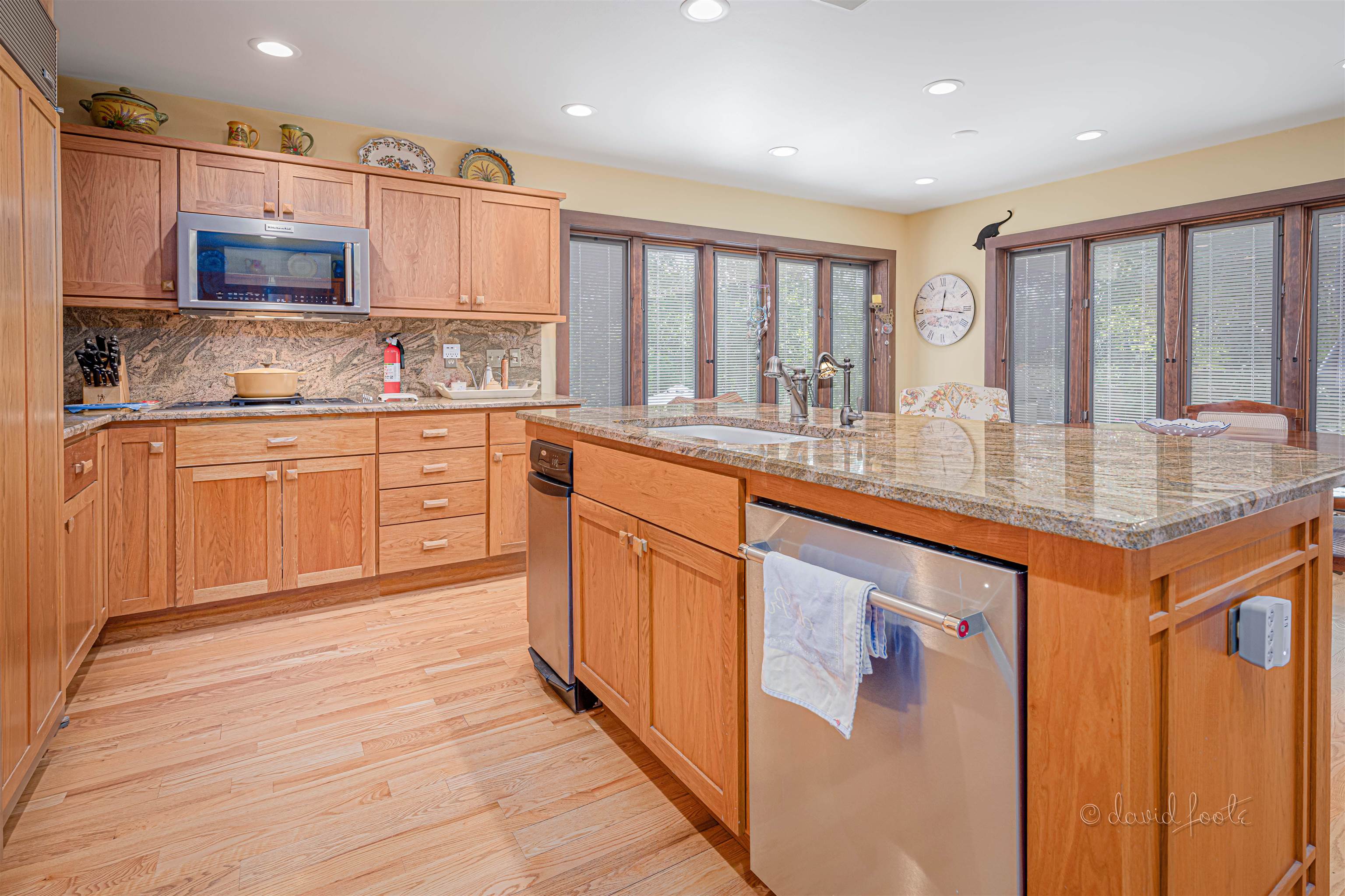 49 High Ridge Run Galena, IL 61036 - Photo 26 of 81 a kitchen with stainless steel appliances granite countertop a stove top oven a sink dishwasher and cabinets with wooden floor