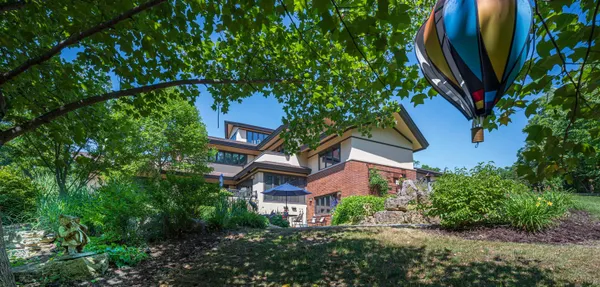 an aerial view of a house with swimming pool and a yard