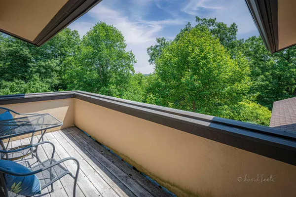 an aerial view of a house with a yard and lake view