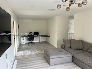11545 Southwest 109th Road, Unit 25W Miami, FL 33176 - Photo 5 of 16 a living room with furniture and a flat screen tv