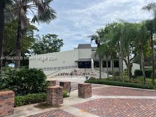 11545 Southwest 109th Road, Unit 25W Miami, FL 33176 - Photo 10 of 16 a view of a building with garden and trees