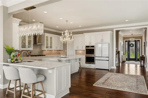 a kitchen with a sink and chairs