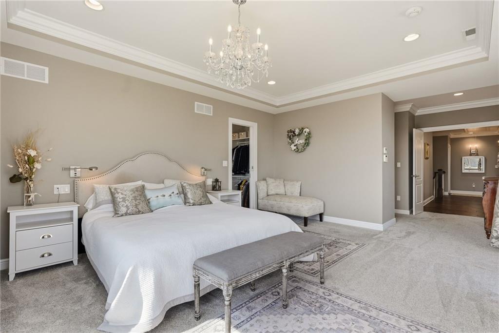 1690 Shelburne Lane Pittsburgh, PA 15217 - Photo 23 of 50 a bedroom with a bed and a chandelier