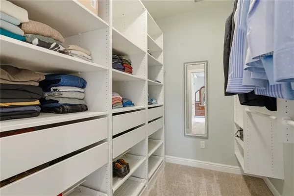 a spacious bathroom with a double vanity sink a mirror a bathtub and next to a window