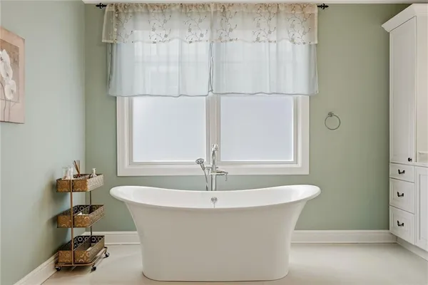a bathroom with a double vanity sink mirror and shower