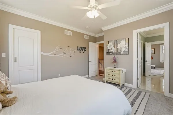 a bedroom with furniture and a large window