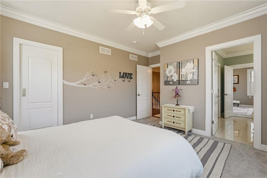 1690 Shelburne Lane Pittsburgh, PA 15217 - Photo 36 of 50 a bedroom with a bed and a chandelier