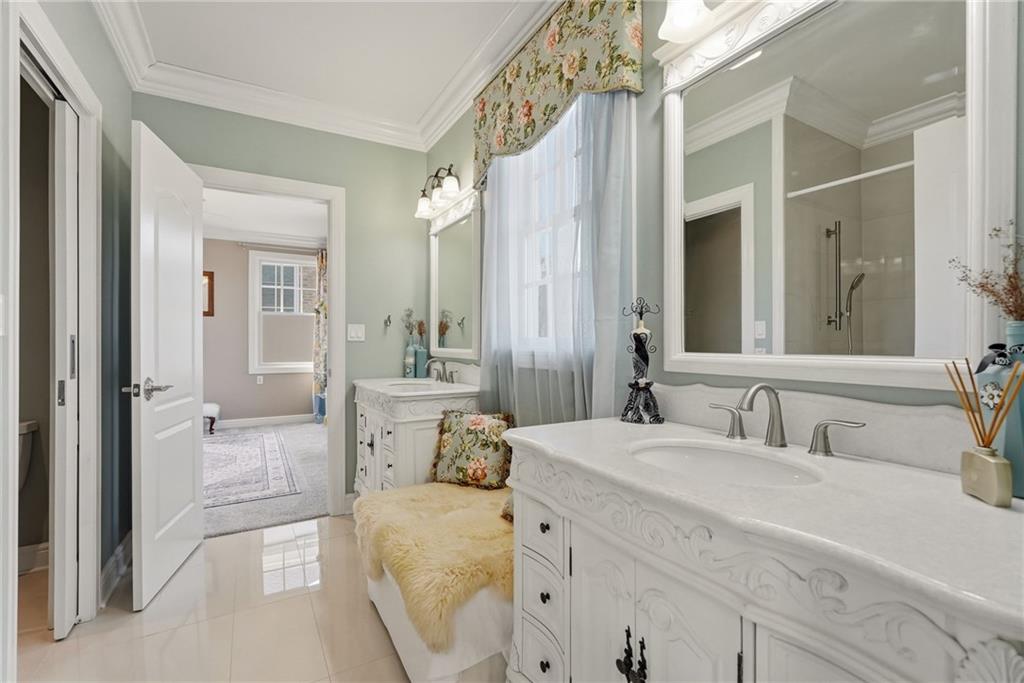 1690 Shelburne Lane Pittsburgh, PA 15217 - Photo 38 of 50 a en suite bathroom with a double vanity sink a mirror and a shower