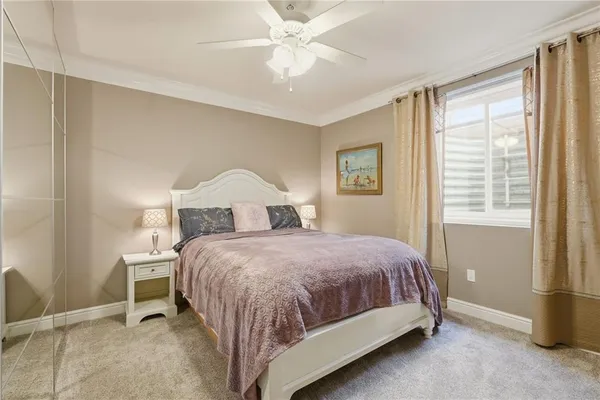 a bathroom with a toilet a sink a glass door a shower a mirror and vanity