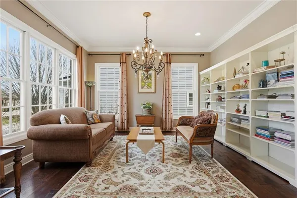 a living room with furniture and a chandelier