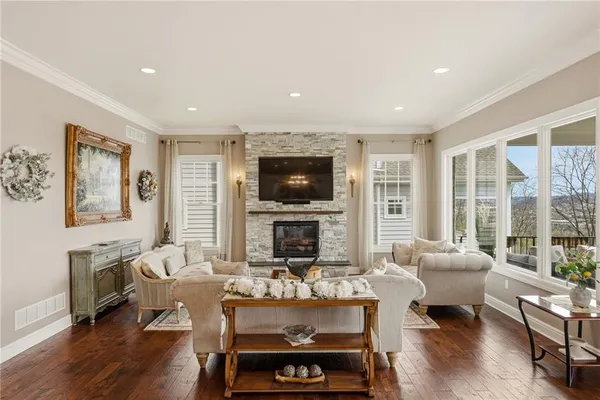 a living room with fireplace furniture and a flat screen tv