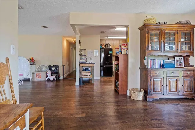 a view of a living room with kitchen and furniture