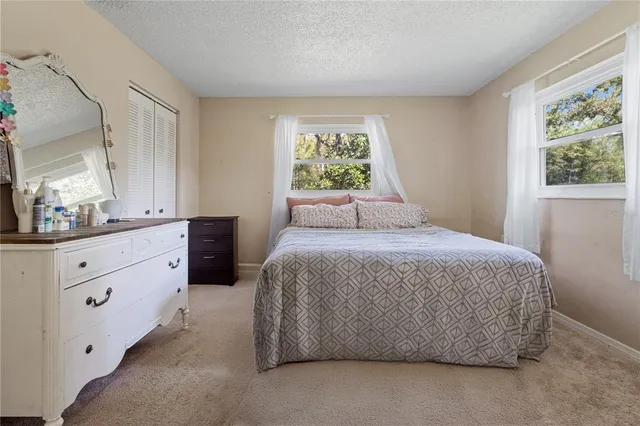 a spacious bedroom with a large bed and a window