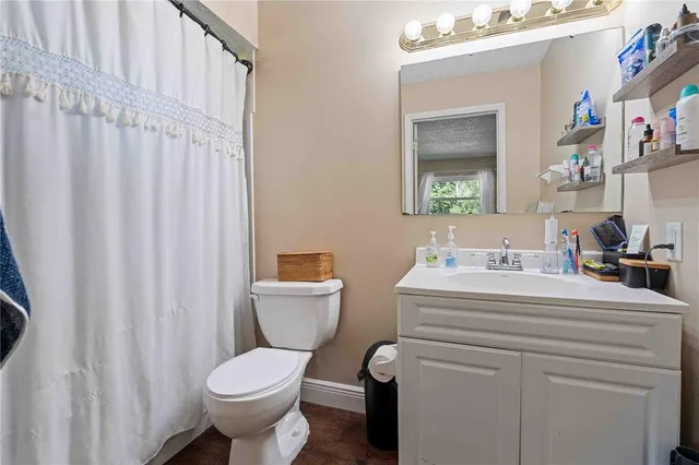 a bathroom with a sink toilet and a mirror