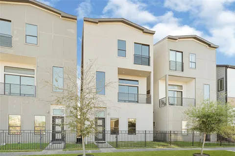 a view of a white apartments with large windows