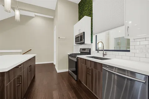 a kitchen with a sink and a stove top oven