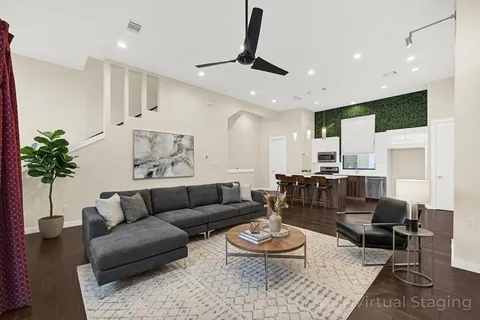 a living room with furniture and a potted plant