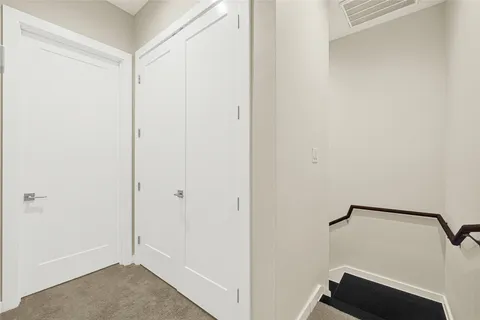 a view of room with hallway and closet