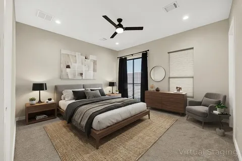 a bedroom with a bed large window and couch