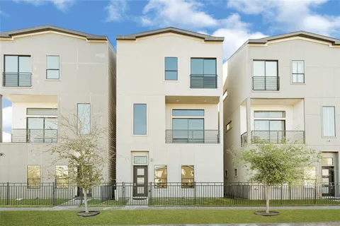 a view of a white building among the palm trees