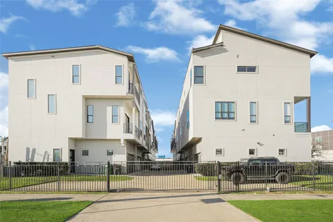 a front view of multi story residential apartment building with yard