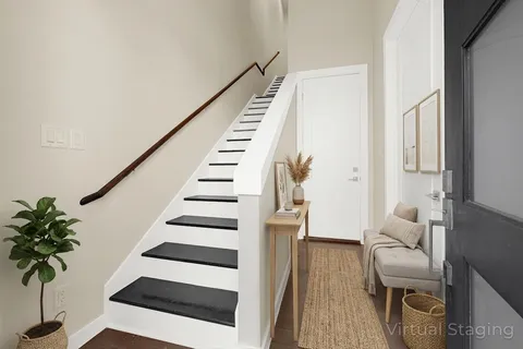 a view of entryway with wooden floor and stairs