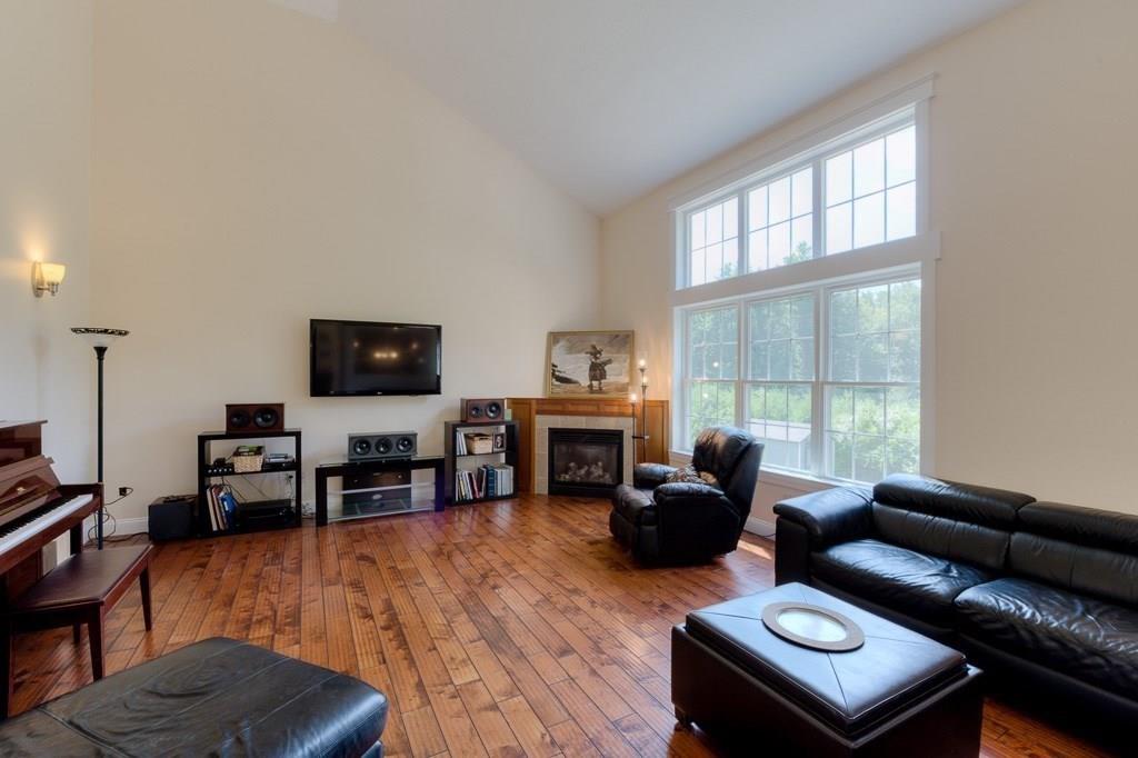 28 Draper Woods Road Sturbridge, MA 01518 - Photo 3 of 41 a living room with furniture a flat screen tv and a large window