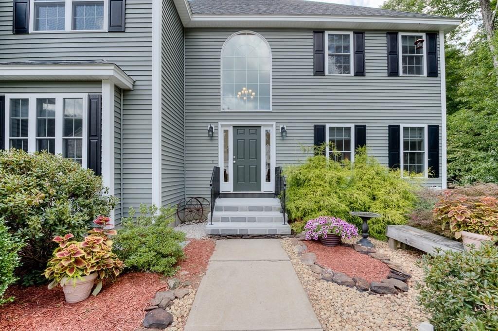 28 Draper Woods Road Sturbridge, MA 01518 - Photo 41 of 41 a front view of a house with a garden
