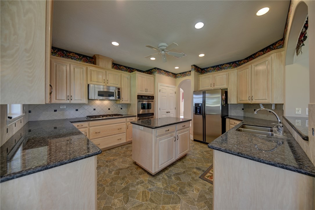 2120 Hohenwalde School Road Brenham, TX 77833 - Photo 11 of 23 a kitchen with granite countertop a sink a counter top space stainless steel appliances and cabinets