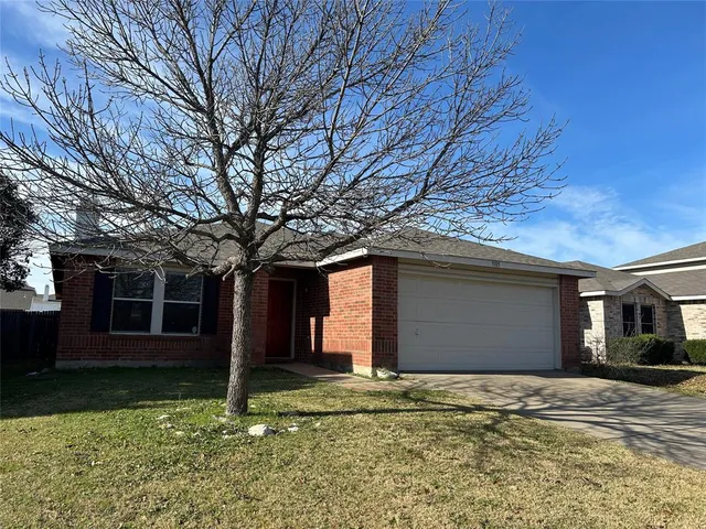 a house that has a tree in front of it