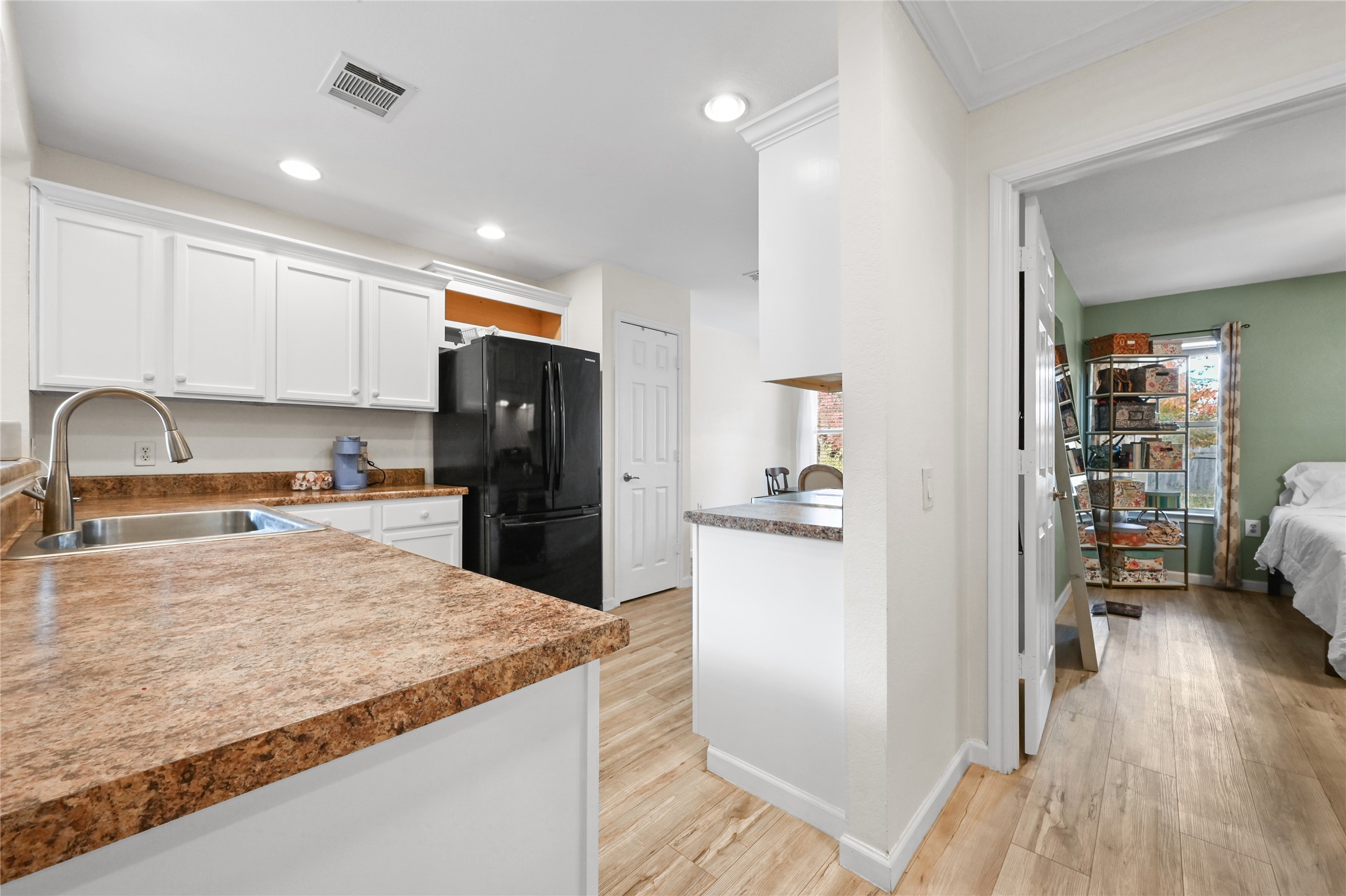 7620 Cayenne Lane Austin, TX 78741 - Photo 11 of 27 a kitchen with granite countertop a refrigerator and a sink