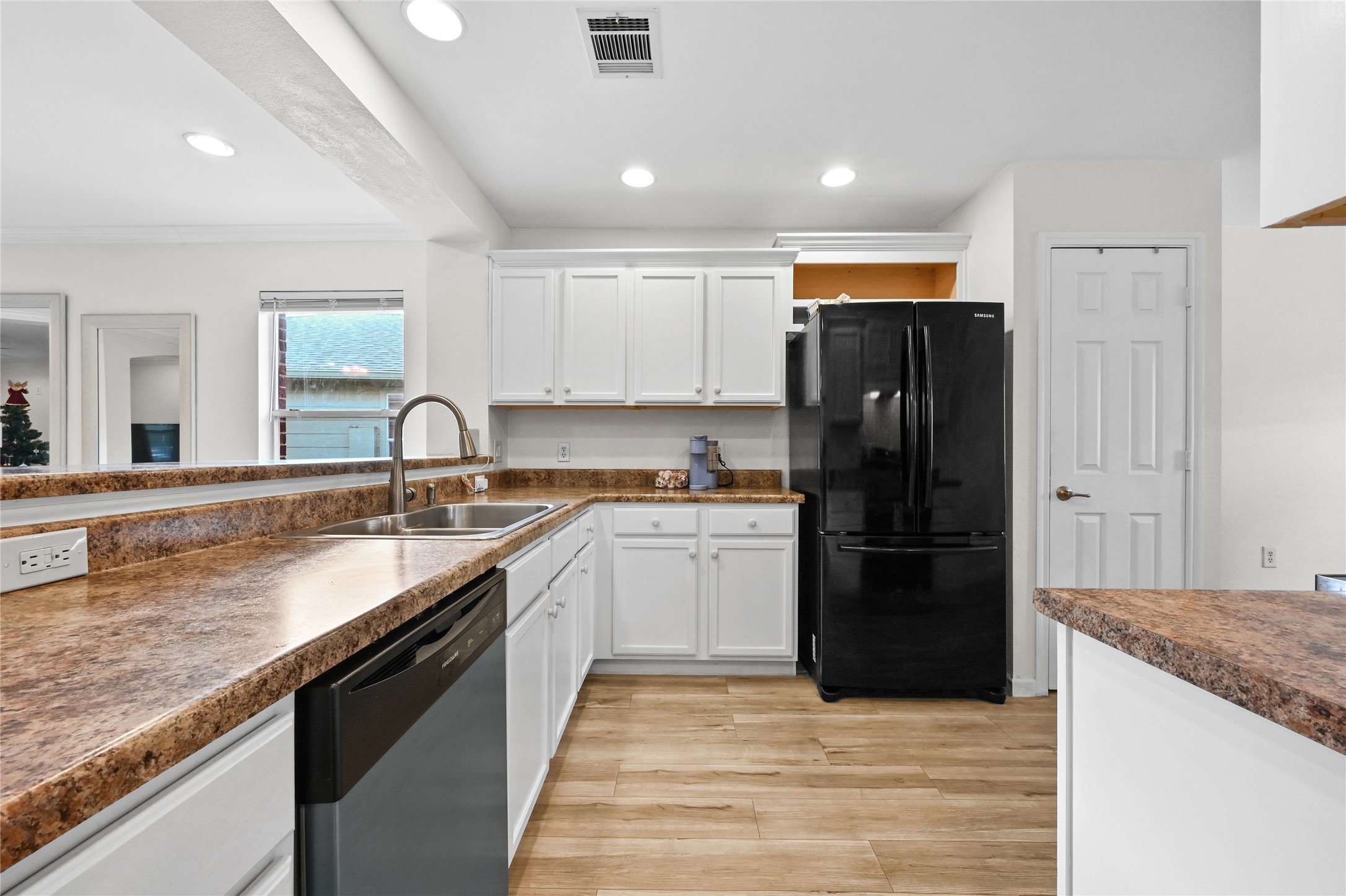 7620 Cayenne Lane Austin, TX 78741 - Photo 12 of 27 a kitchen with a sink and a refrigerator